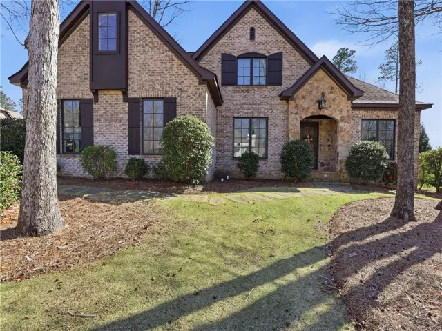 A charming brick exterior with stone accents welcomes you home to this picturesque residence.