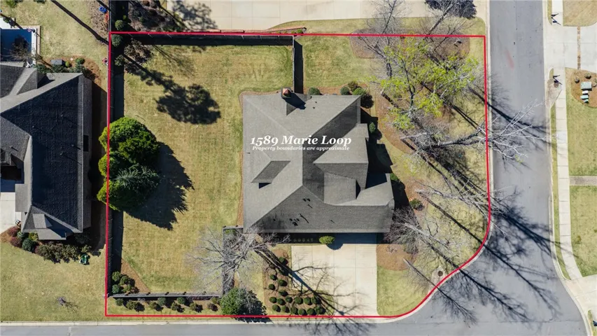 An aerial perspective showcases a generously sized property featuring a well-maintained lawn and mature trees.