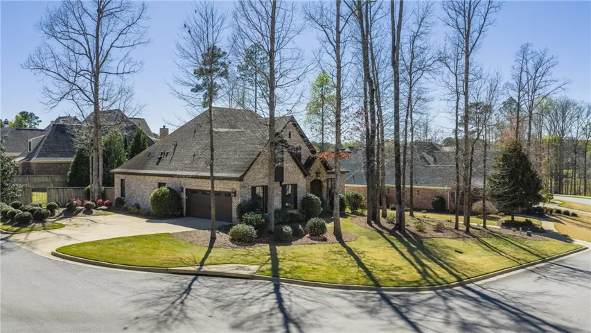 A classic brick exterior with a well-maintained lawn welcomes you to this charming residence.