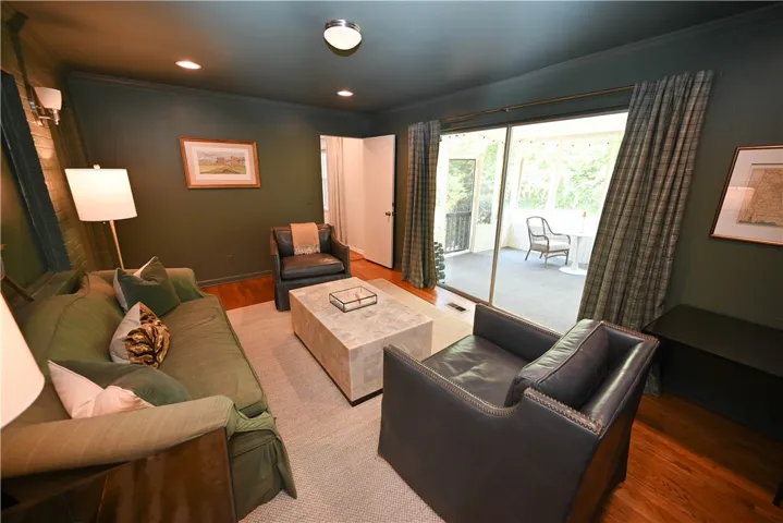 Expansive glass sliders connect the den to the large screen porch.