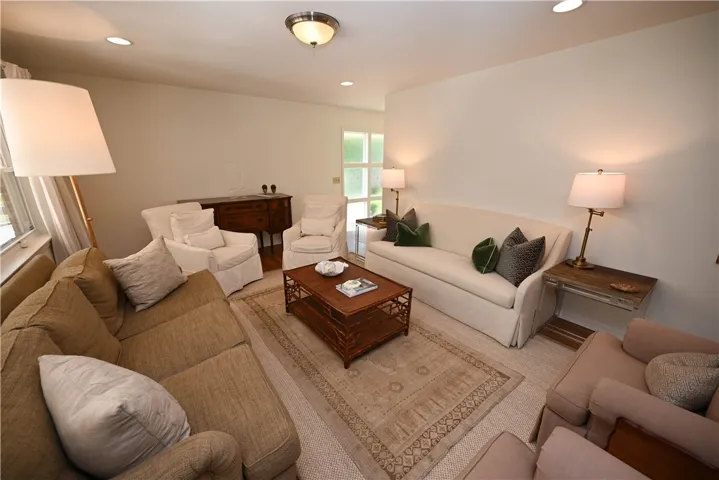 This bright & inviting living room offers ample space for relaxation & entertaining.