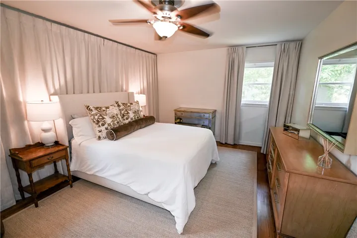 Spacious & restful primary bedroom featuring hardwood floors & en-suite bath.