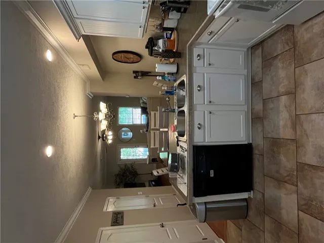 This bright kitchen with ample cabinet space opens to the dining area.