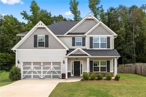 This classic two-story residence features a welcoming facade and mature landscaping.