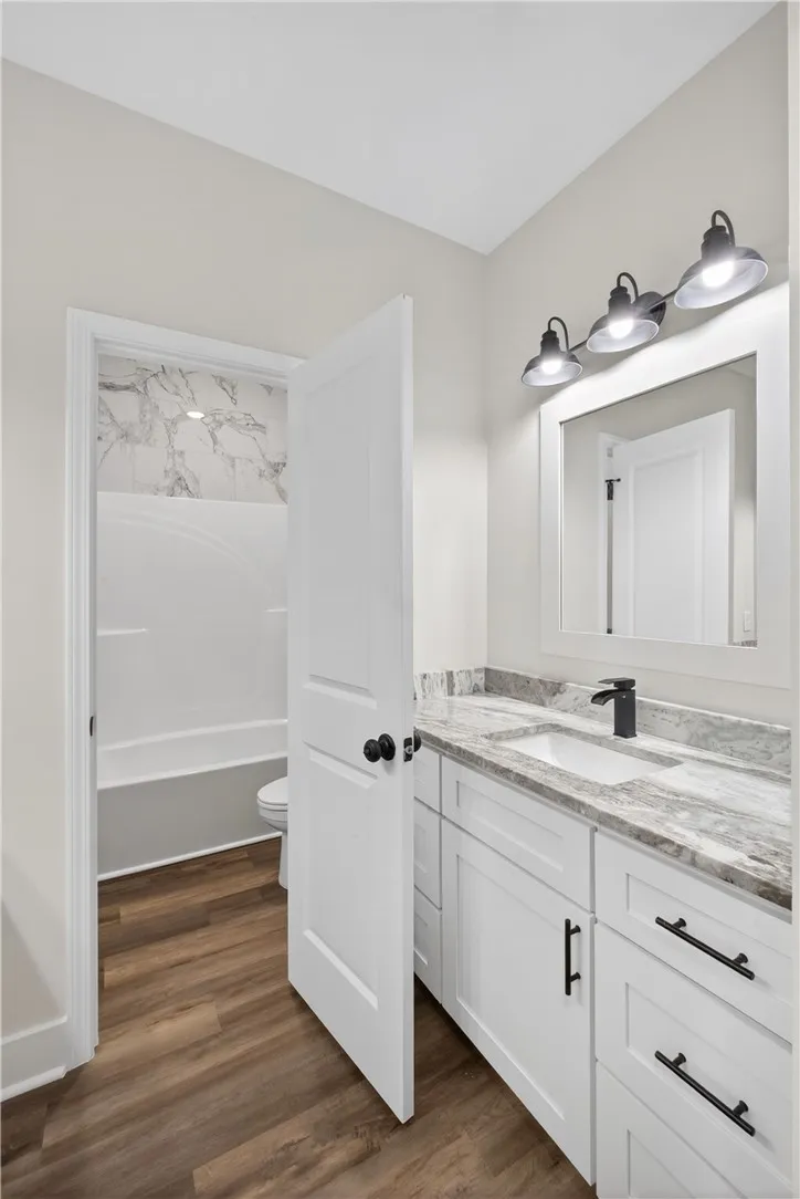 This bathroom features a contemporary vanity with a sleek faucet and stylish overhead lighting.