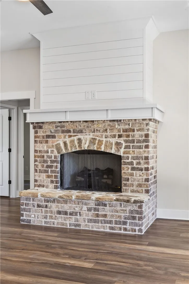 This living room features a beautifully crafted brick fireplace, adding character to the space.