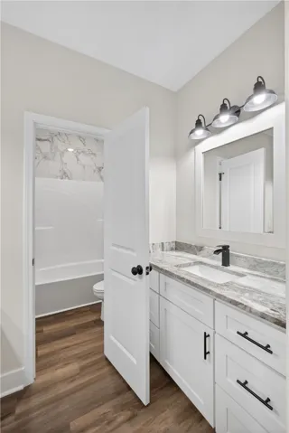 This bathroom features a contemporary vanity with a sleek faucet and stylish overhead lighting.