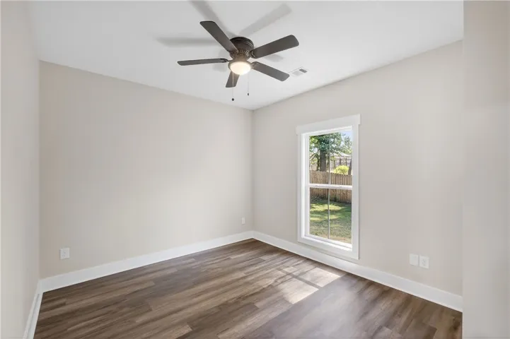 This bright room features a large window, inviting natural light into the space.