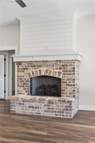 This living room features a beautifully crafted brick fireplace, adding character to the space.