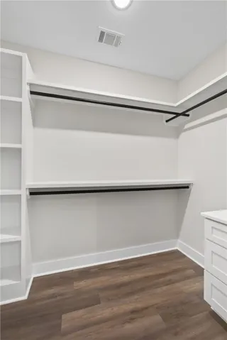 This spacious walk-in closet offers ample storage and organization for your wardrobe.