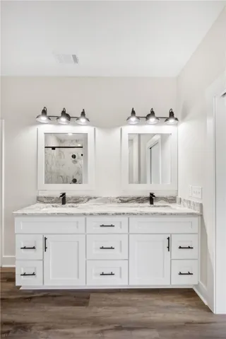 This modern bathroom features a double vanity with ample storage and sleek fixtures.