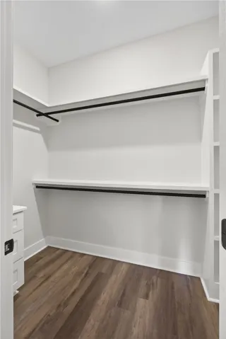 This spacious walk-in closet features ample shelving and hanging space for organized storage.