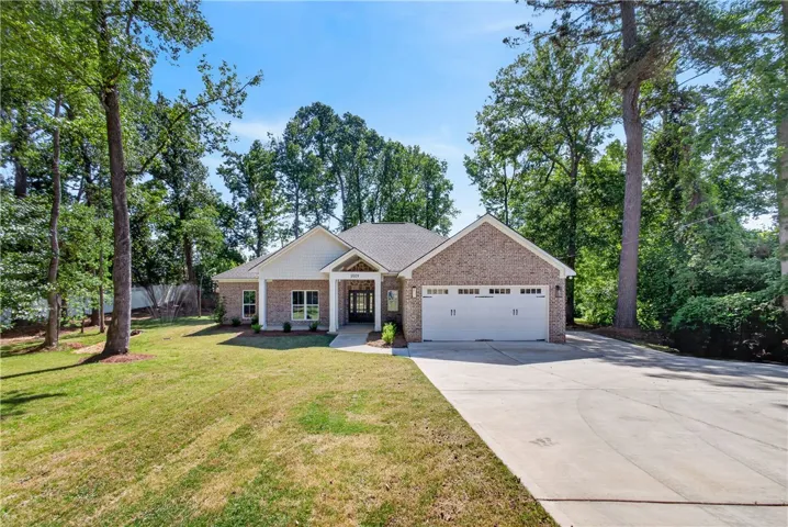 This charming home features a classic brick exterior and a welcoming front entrance.