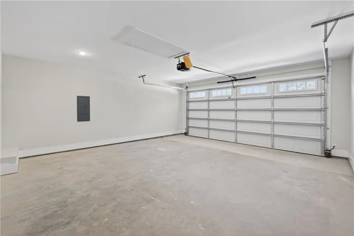 This spacious garage offers ample parking and additional storage solutions for your needs.