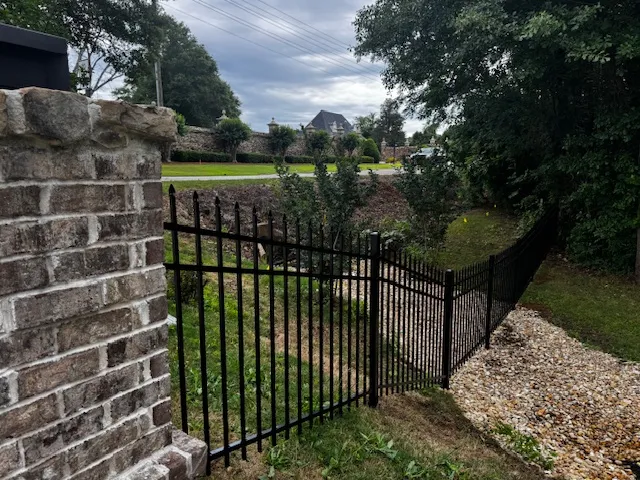 Secure the property with this durable fence, offering privacy and a defined boundary.