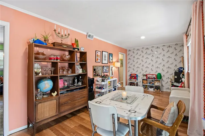 This versatile room features hardwood floors and a combination of smooth and textured wall finishes.