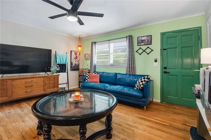 Warm wood floors and light walls create an inviting ambiance in this bright living space.
