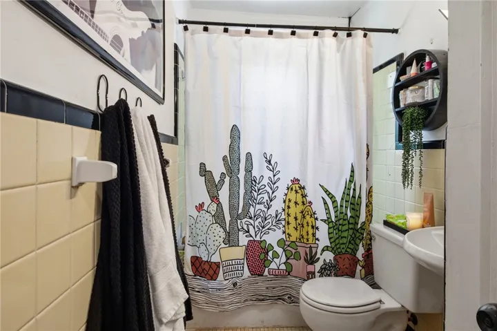 This bright bathroom features classic tile work and a functional layout.