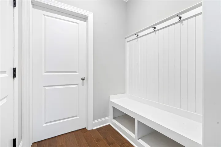 A well-appointed mudroom offers built-in bench seating and convenient coat hooks for everyday organization.