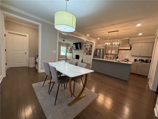 This open concept space offers seamless transitions between dining, cooking, and living areas.