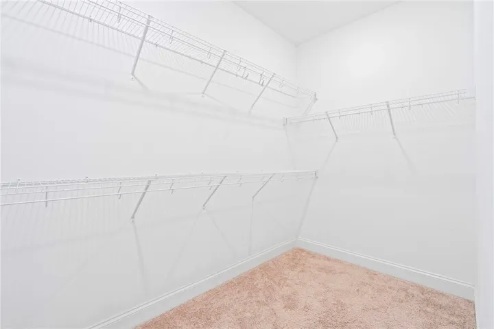 Ample wire shelving provides versatile storage options in this well-organized closet space.