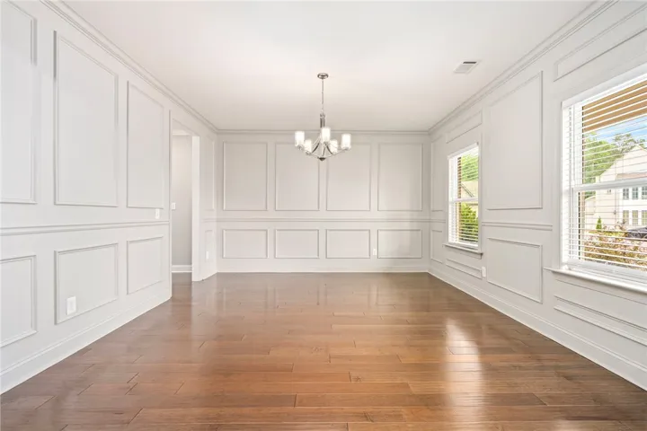 Elegant wall molding and gleaming hardwood floors define this inviting dining area.