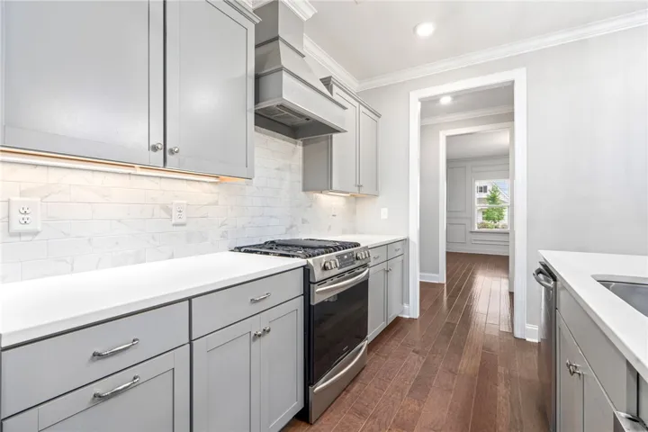 Culinary delights await in this bright kitchen, complete with stainless steel appliances and abundant counter space.