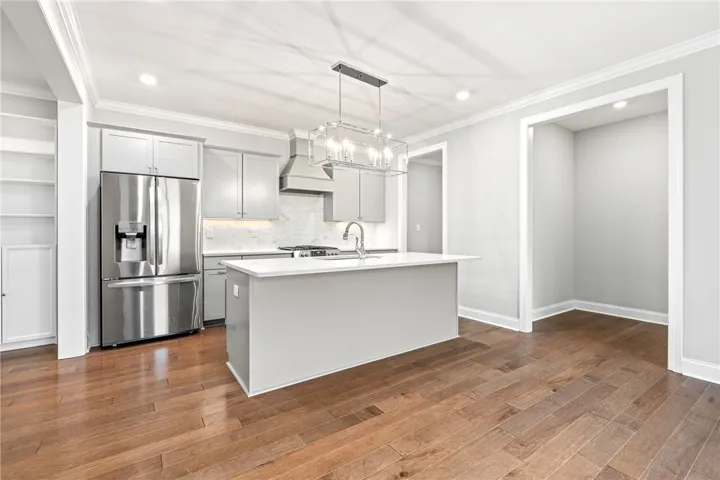 Culinary creations come to life in this kitchen, featuring stainless steel appliances and an expansive island.