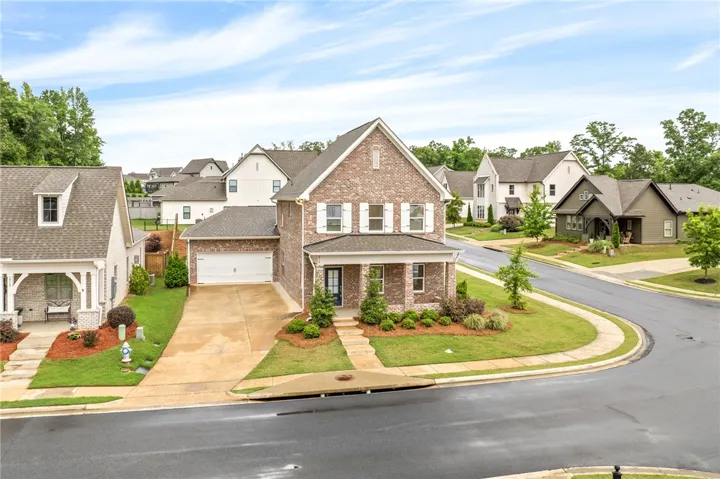 A classic brick exterior with white shutters offers a welcoming curb appeal in this residential setting.