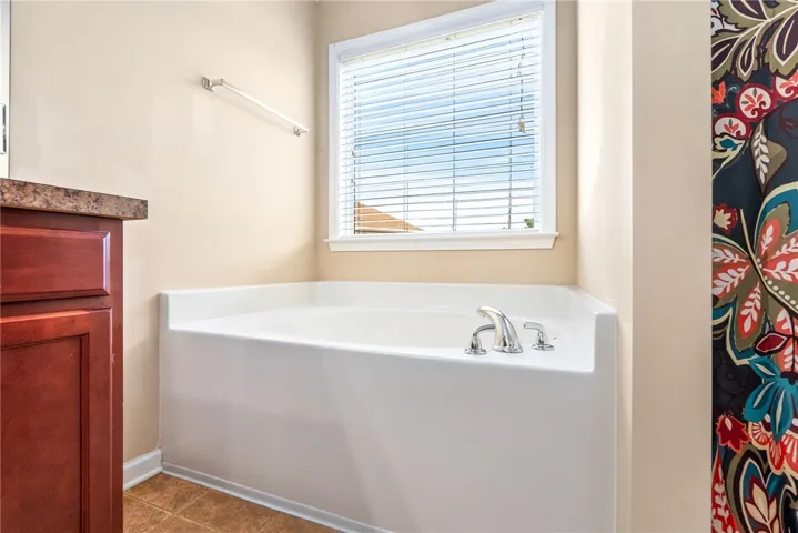Relax in this tranquil corner soaking tub, perfect for unwinding after a long day.