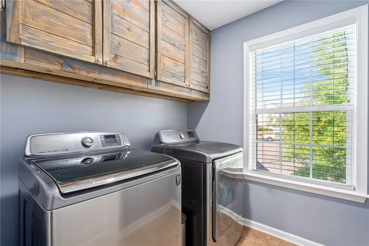 This functional laundry room features convenient appliances and ample storage.
