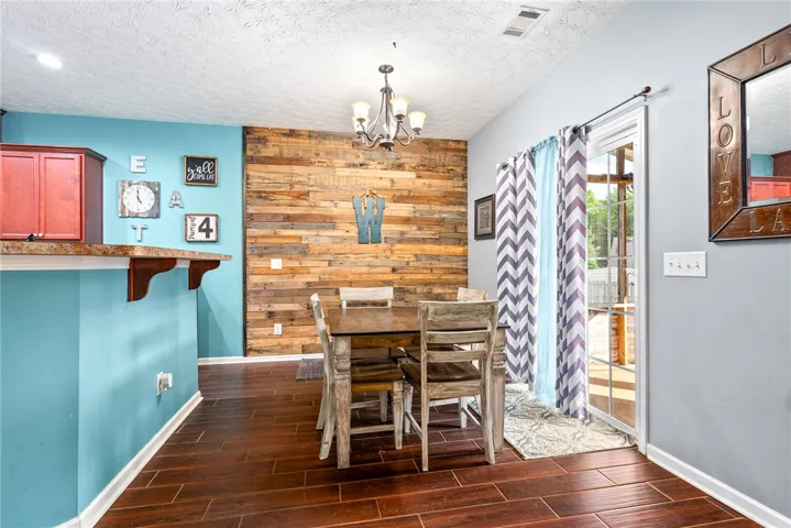 This inviting dining area features warm wood accents and gleaming flooring, perfect for memorable gatherings.