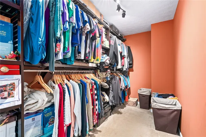 Ample built-in storage solutions and thoughtful lighting create an organized and inviting space.