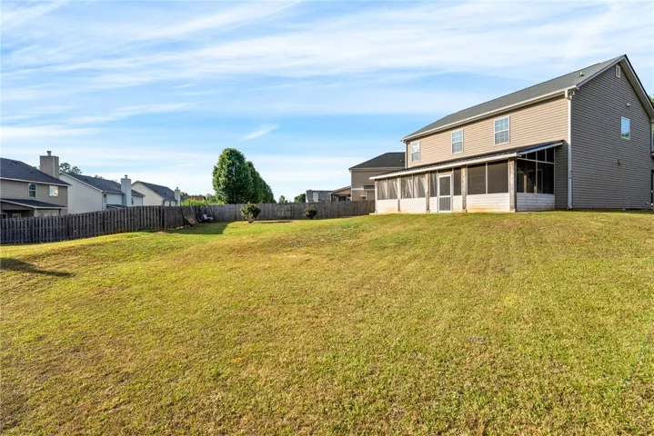 This residence features a vast fenced yard, perfect for recreation and outdoor enjoyment.
