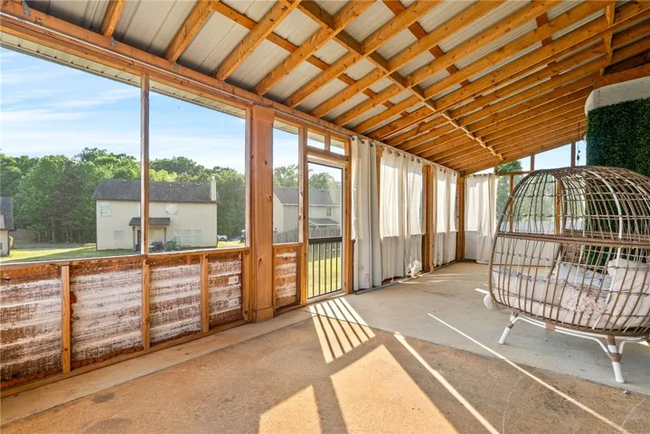 This spacious screened porch offers a tranquil retreat with open views.