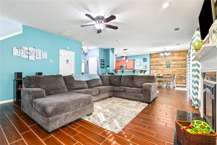 This inviting space features an open layout with rich wood flooring, perfect for gatherings.