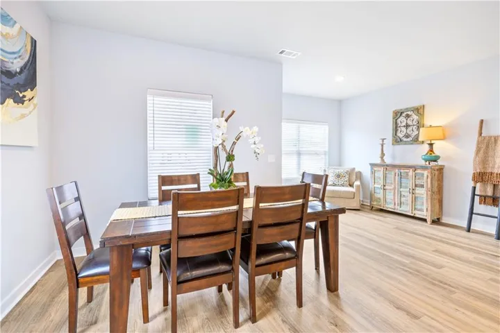This bright and open dining area offers seamless flow and a welcoming atmosphere.