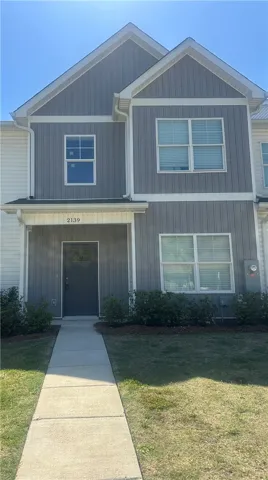 This modern residence showcases a clean facade and well-maintained grounds, offering a welcoming exterior.