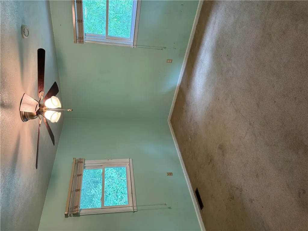 A well-lit bedroom with soft carpeting awaits your personal touch.