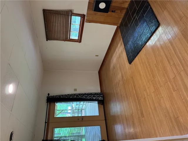 Durable laminate flooring pairs with a dark-tiled hearth for practical interior living.