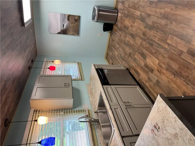 A well-appointed kitchen showcasing durable wood-look flooring and ample cabinetry for storage.