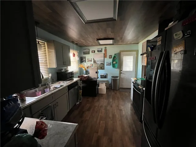 This kitchen features sleek black appliances and ample counter space.