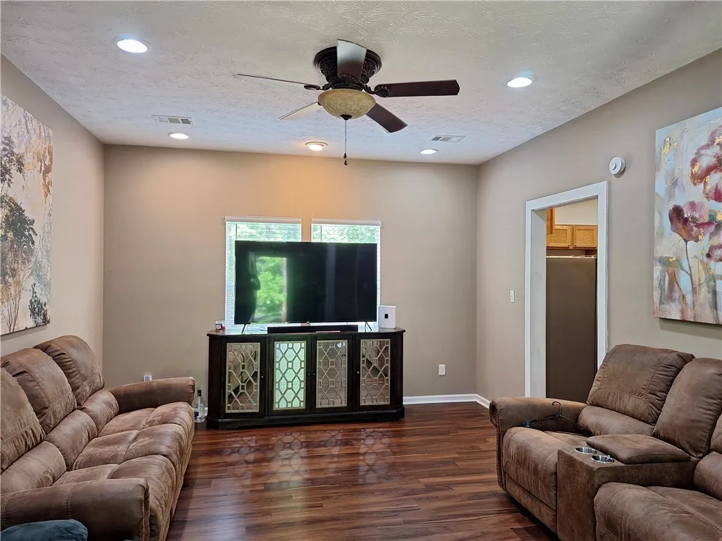 This inviting living area features warm wood flooring and ample natural light.