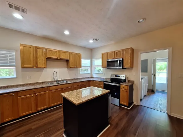 This spacious kitchen offers a functional layout with ample cabinet space.