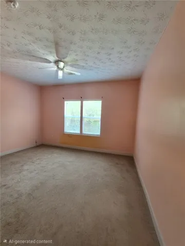 This spacious room features a ceiling fan, plush carpet, and ample natural light.