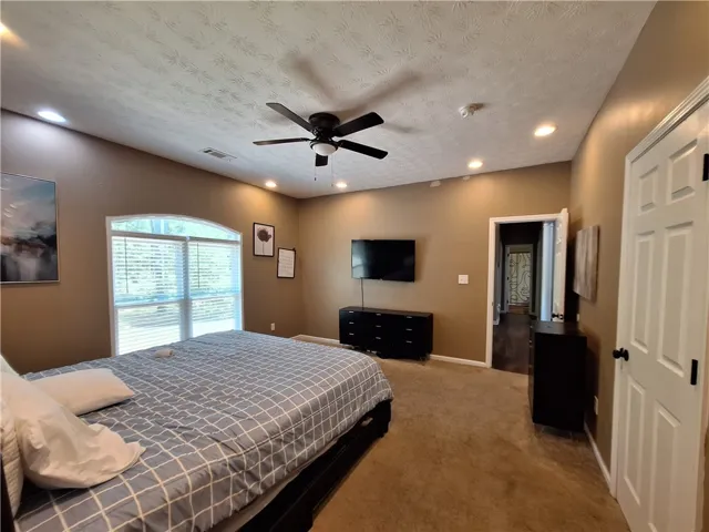 This spacious bedroom offers comfort and a tranquil atmosphere for ultimate relaxation.