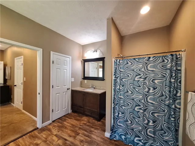 This bathroom features durable flooring and practical fixtures, creating a functional space.