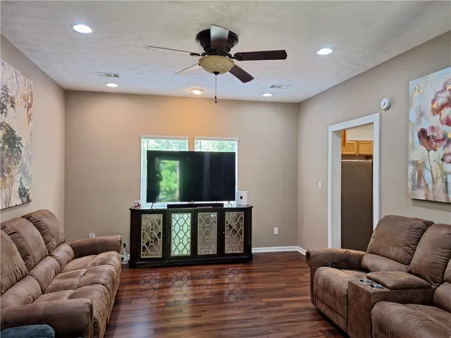 This inviting living area features warm wood flooring and ample natural light.