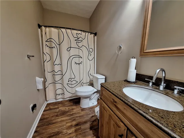 This bright bathroom features a spacious vanity and ample natural light.