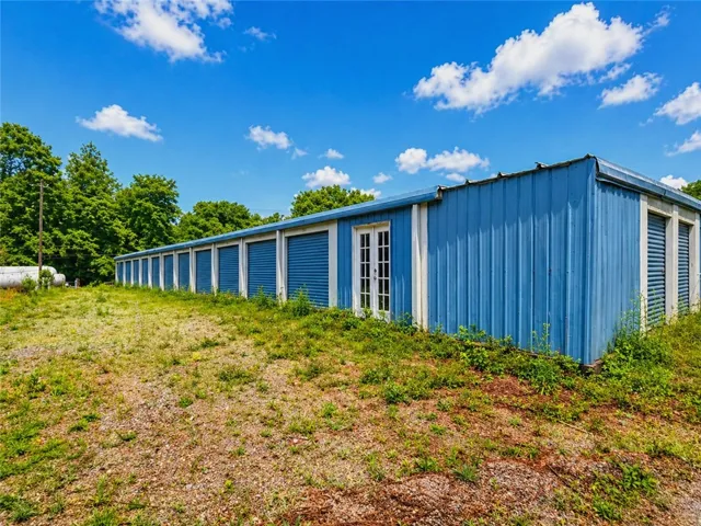 This structure features a vibrant blue exterior, offering practical storage solutions.
